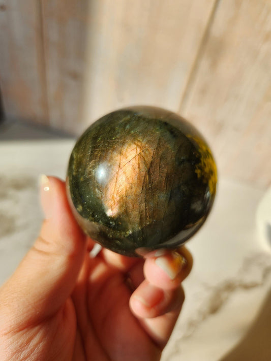 Beautiful labradorite sphere with pink and orange sunset flash and hints of blue, 54.4mm