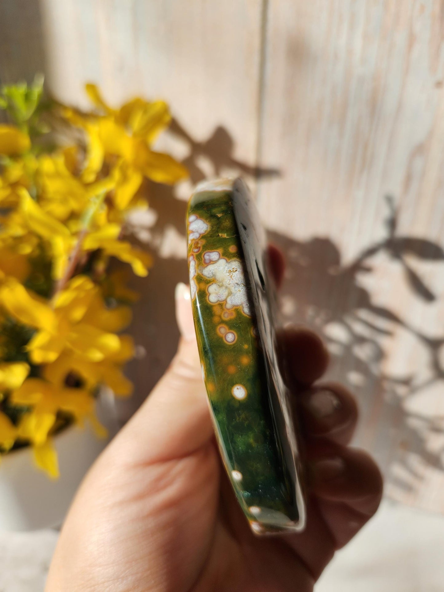 Large pink ocean jasper moon with beautiful colors, patterns, and druzy, stand included