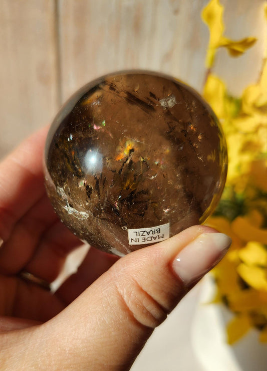 Stunning natural dark smoky quartz sphere with many rainbows and inclusions