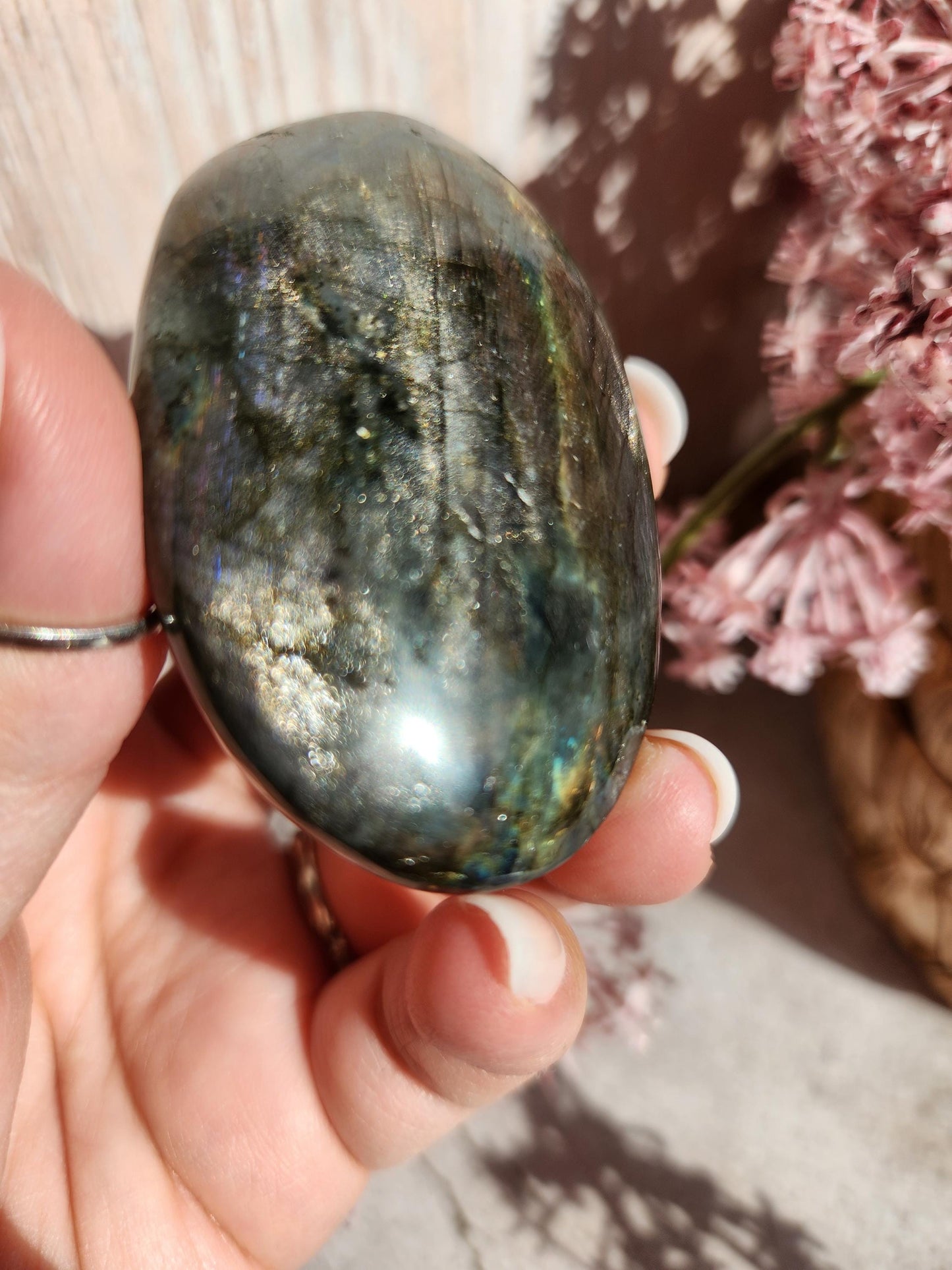 AAA Rainbow purple labradorite palm stone with silver sheen from Finland