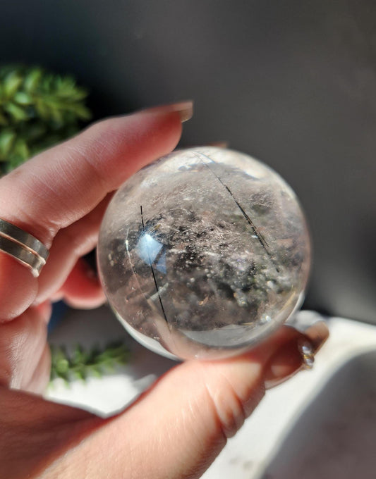 High quality black tourmaline in quartz  sphere with rainbows.