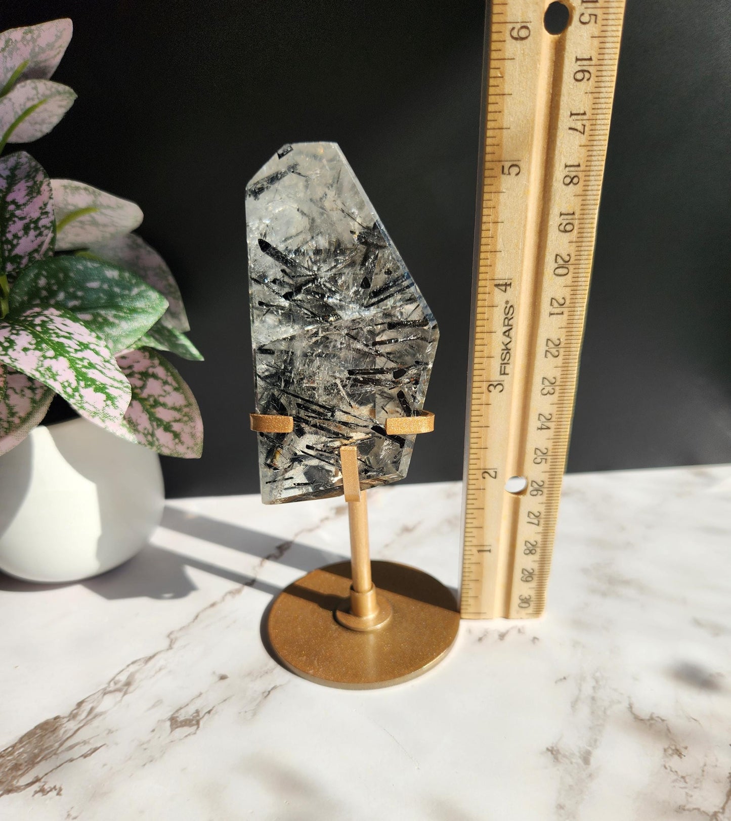 High quality black tourmaline in quartz  freefrom with rainbows on a beautiful gold custom stand