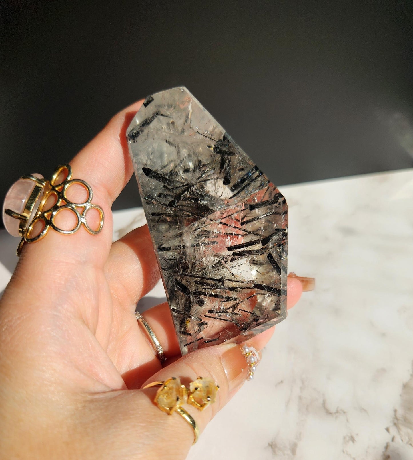 High quality black tourmaline in quartz  freefrom with rainbows on a beautiful gold custom stand
