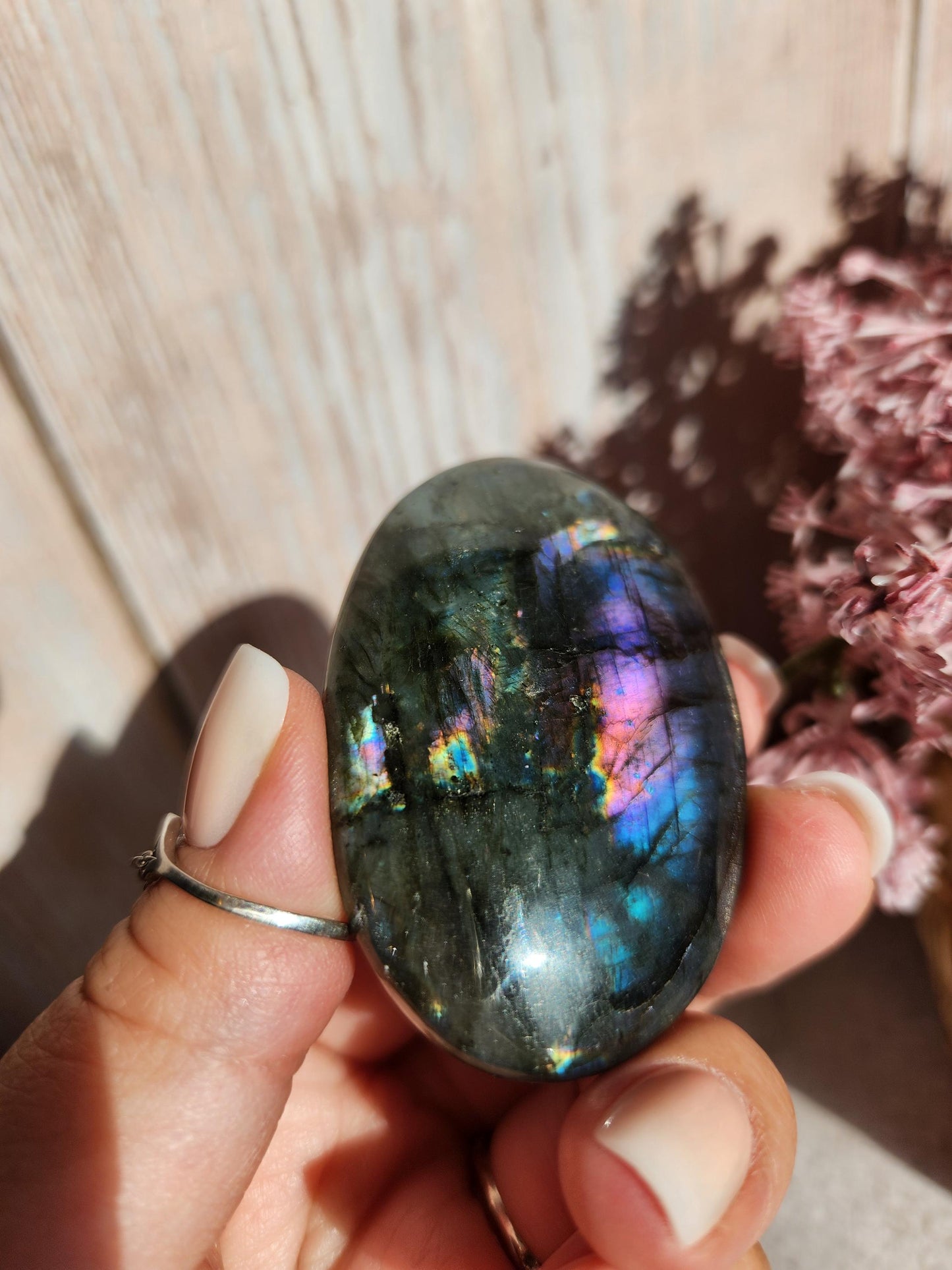AAA Rainbow purple labradorite palm stone with silver sheen from Finland