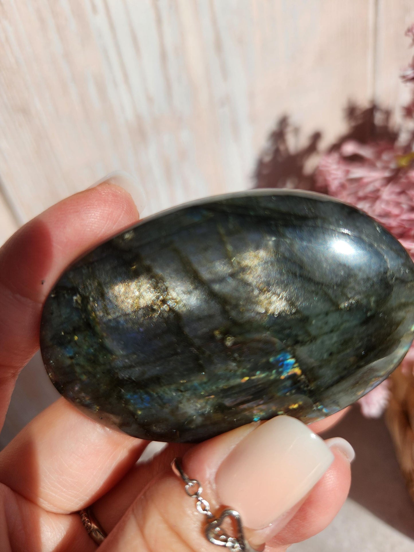 AAA Rainbow purple labradorite palm stone with silver sheen from Finland