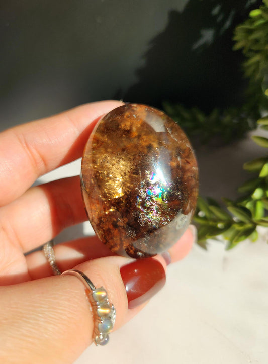 Natural smoky lodolite garden quartz lens from Brazil, half polish and half raw, with a beautiful rainbow