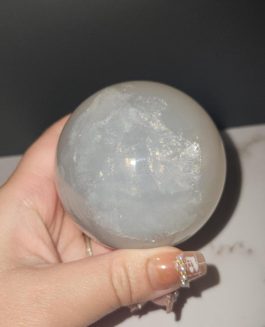 Beautiful blue rose quartz sphere with inclusions and rainbows 67.2mm