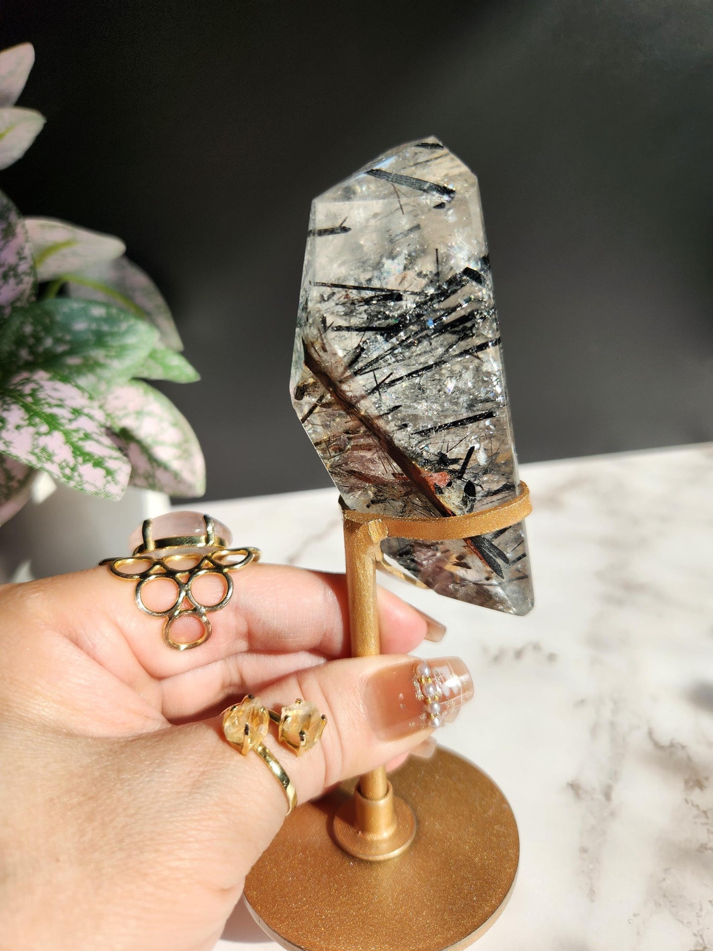 High quality black tourmaline in quartz  freefrom with rainbows on a beautiful gold custom stand
