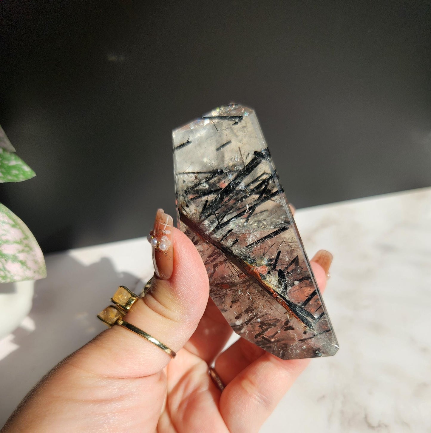 High quality black tourmaline in quartz  freefrom with rainbows on a beautiful gold custom stand
