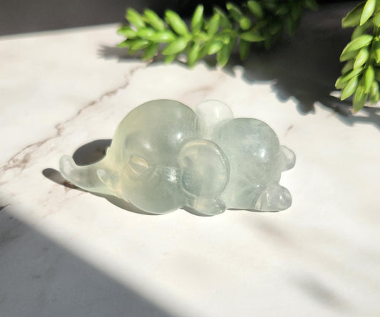 Adorable light green fluorite elephant, laying down elephant carving