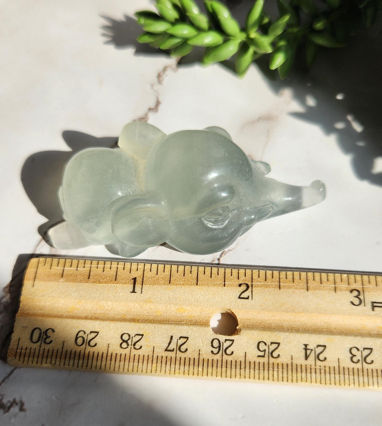 Adorable light green fluorite elephant, laying down elephant carving